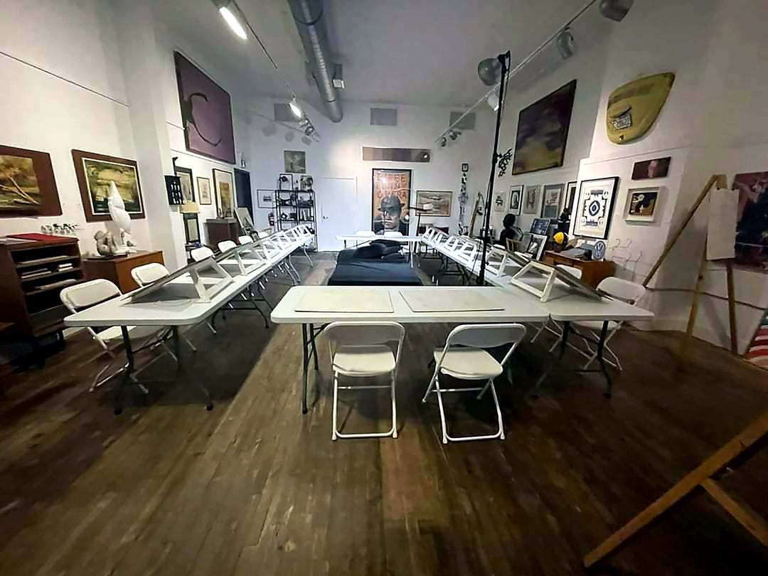Life drawing studio setup with easels and chairs